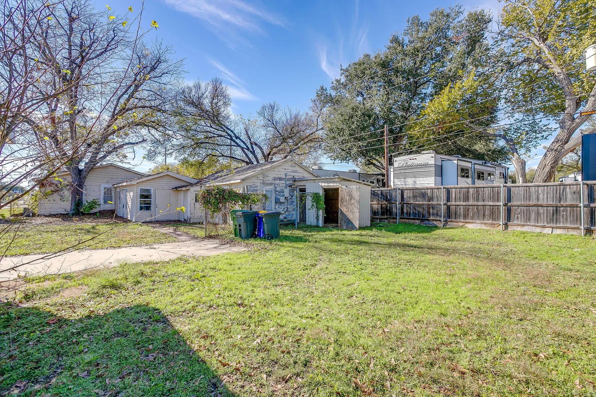 Fenced backyard with an outdoor structure