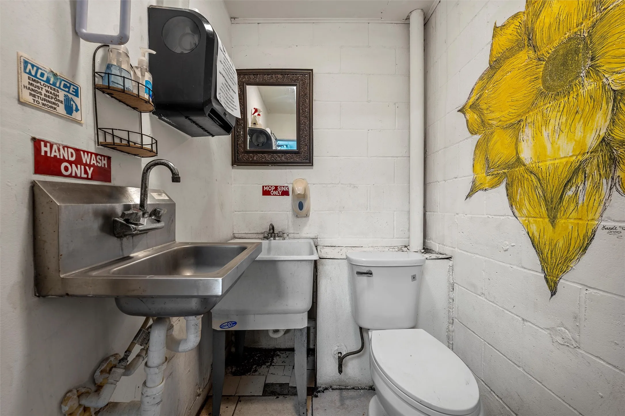 Half bathroom with toilet and concrete block wall
