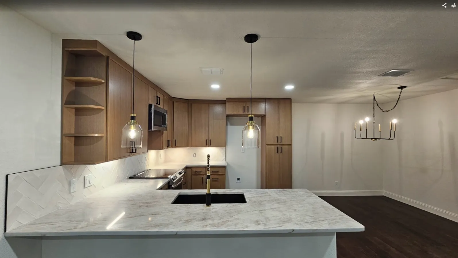 Kitchen featuring open shelves, pendant lighting, light stone counters, electric stove, and a peninsula