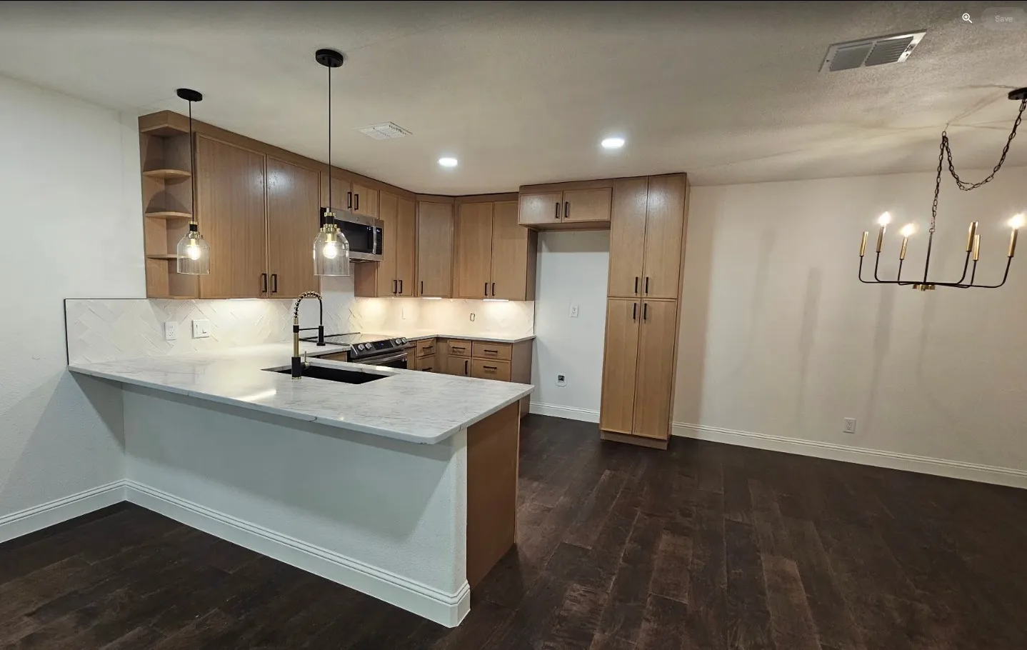 Kitchen with pendant lighting, a peninsula, open shelves, stainless steel appliances, and dark wood finished floors