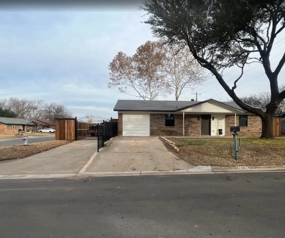Single story home featuring concrete driveway, an attached garage, and brick siding