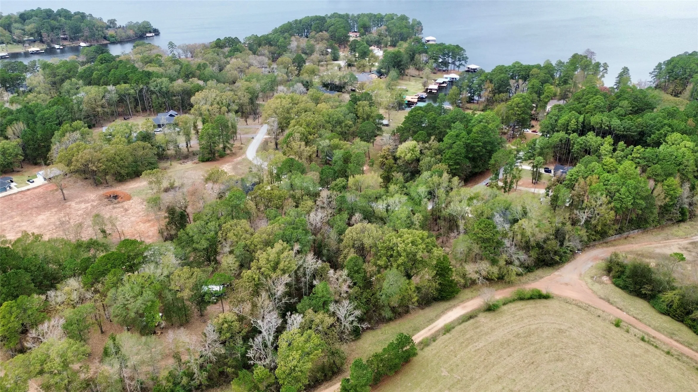 Aerial view of property and surrounding area with a nearby body of water