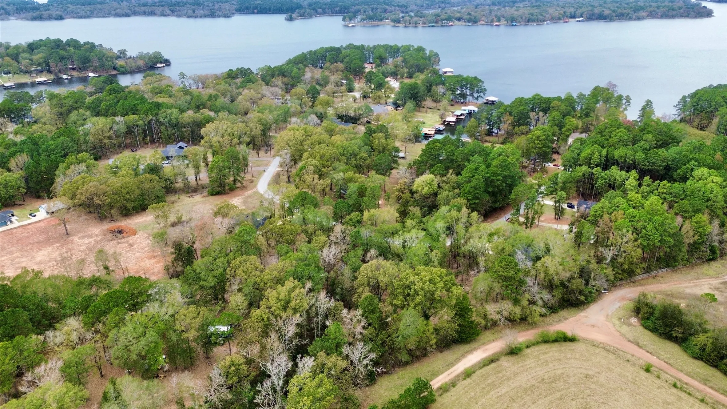 Aerial view of property and surrounding area featuring a large body of water