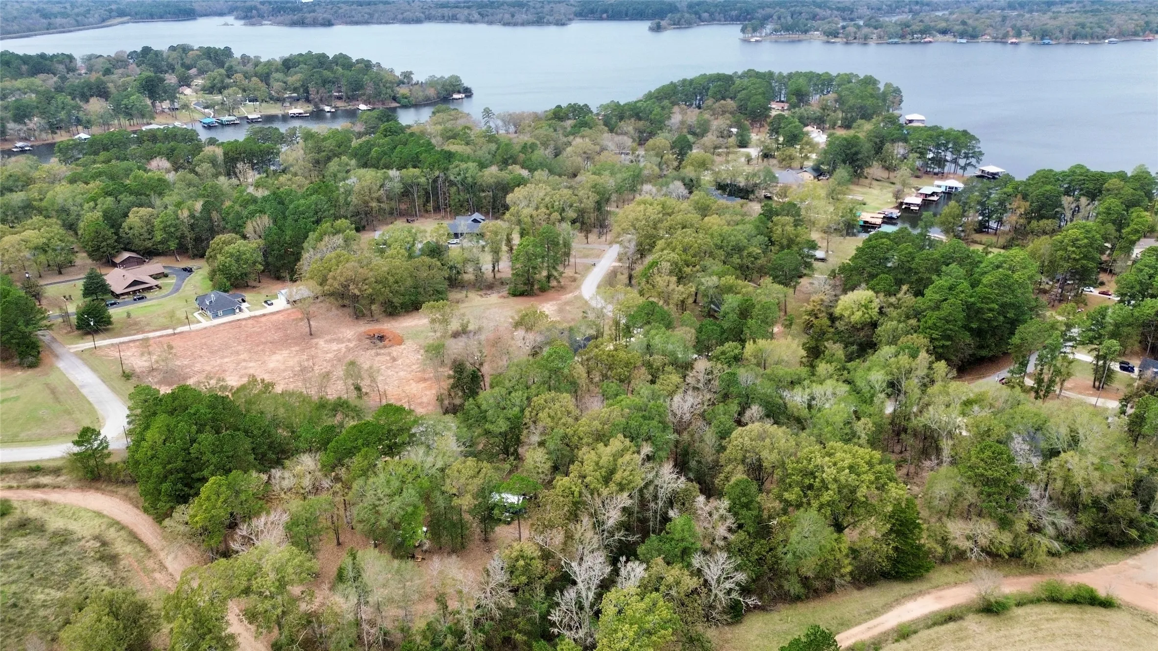 Bird's eye view of a heavily wooded area and a large body of water