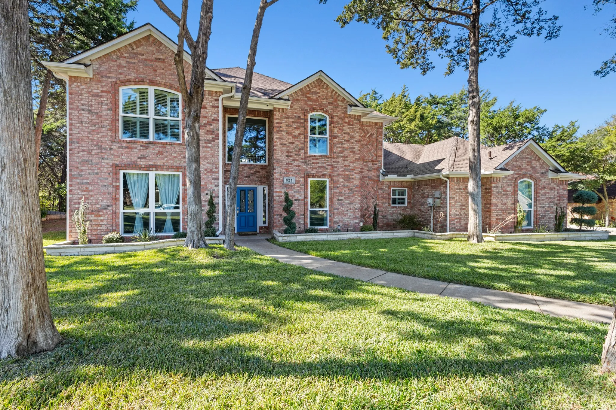 Traditional-style house with a front lawn and brick siding