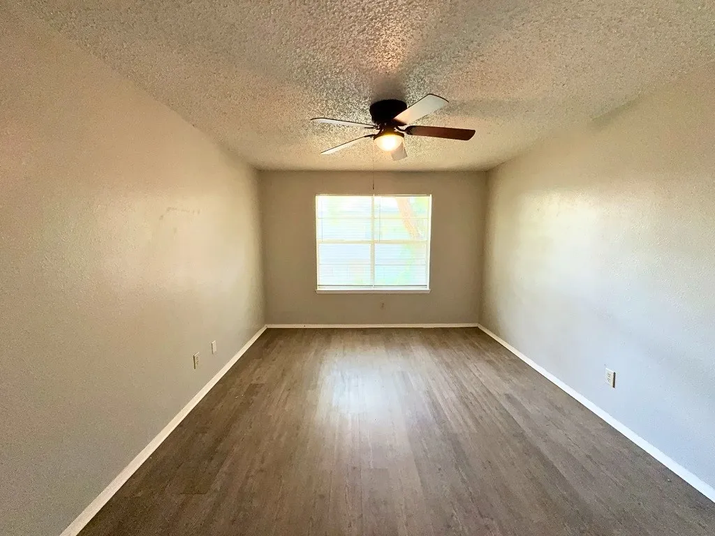 Bedroom with ceiling fan and natural light