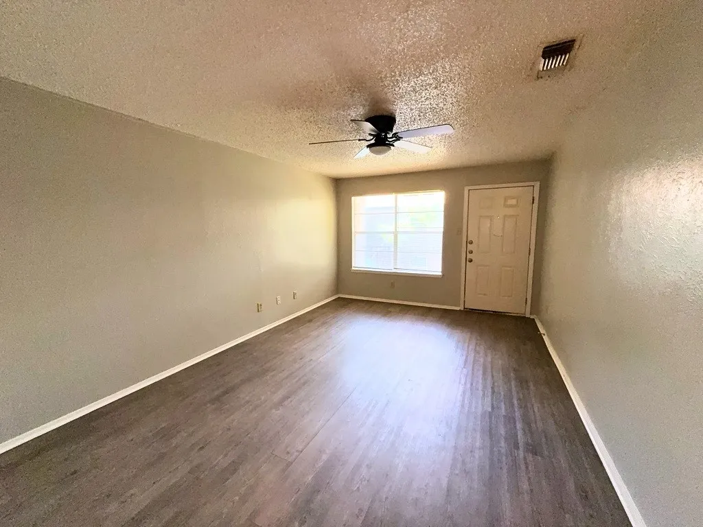 
Living room with ceiling fan and natural light