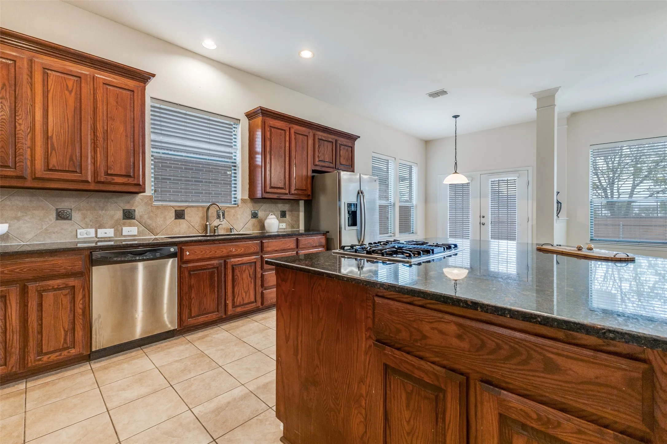 This kitchen features lots of cabinet storage as well as plenty of kitchen prep space.