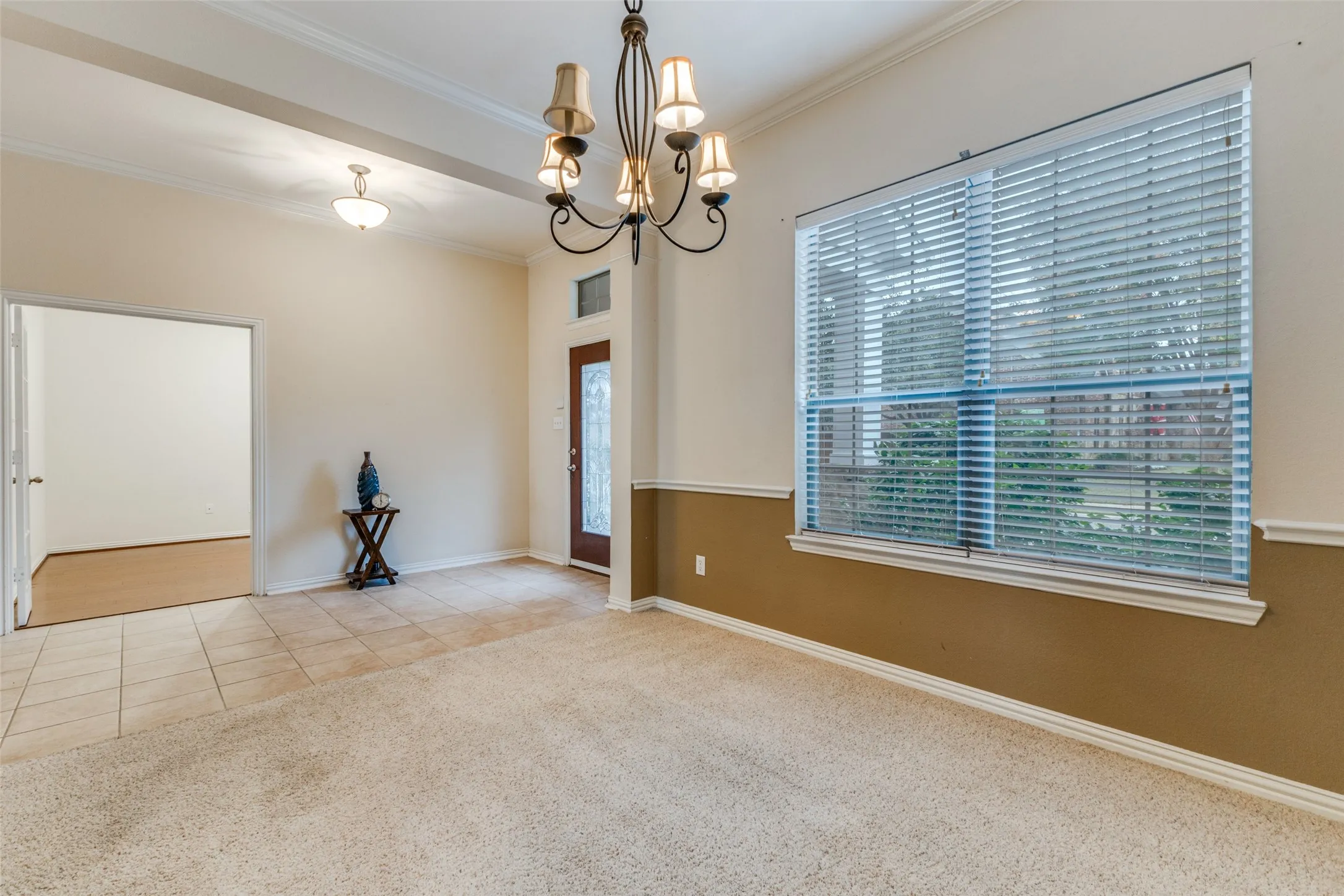 View from the dining room into the foyer and study. Lots of space and dramatic lighting makes this space perfect for your gatherings.