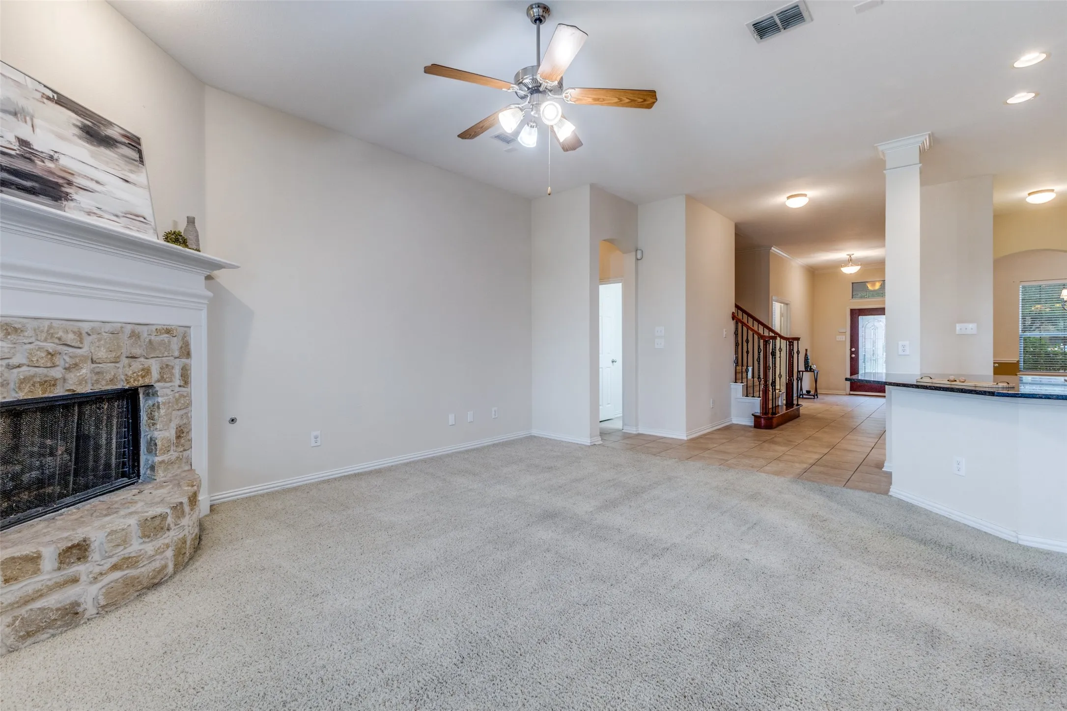 The living areas flow from the family room into the dining and kitchen spaces.