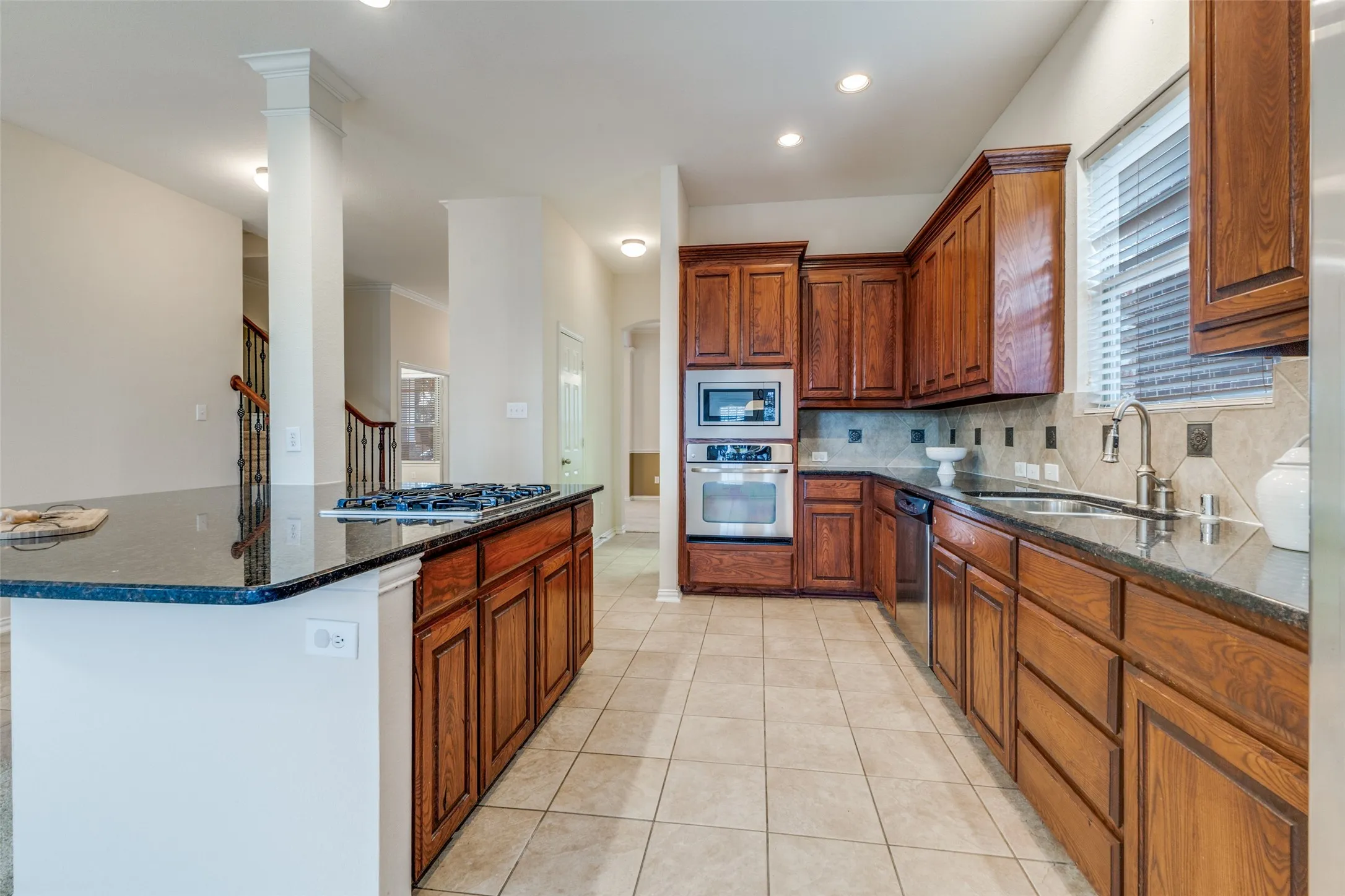 The kitchen features stainless steel appliances and lots of counter top space.