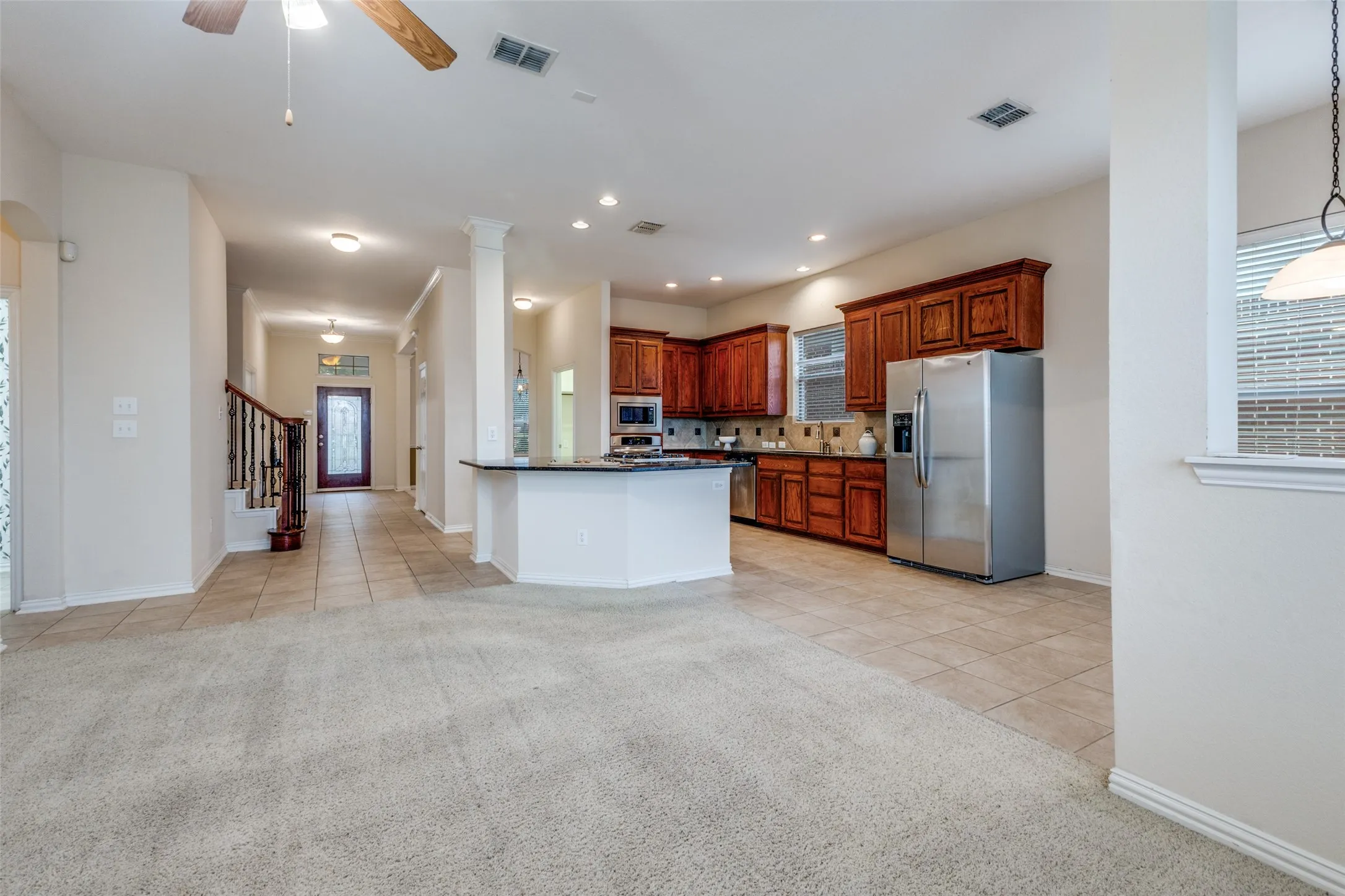 The kitchen is at the heart of this home! Enjoy generous pantry and cabinet storage and granite counter tops. The large breakfast bar - island provides prep and storage space.