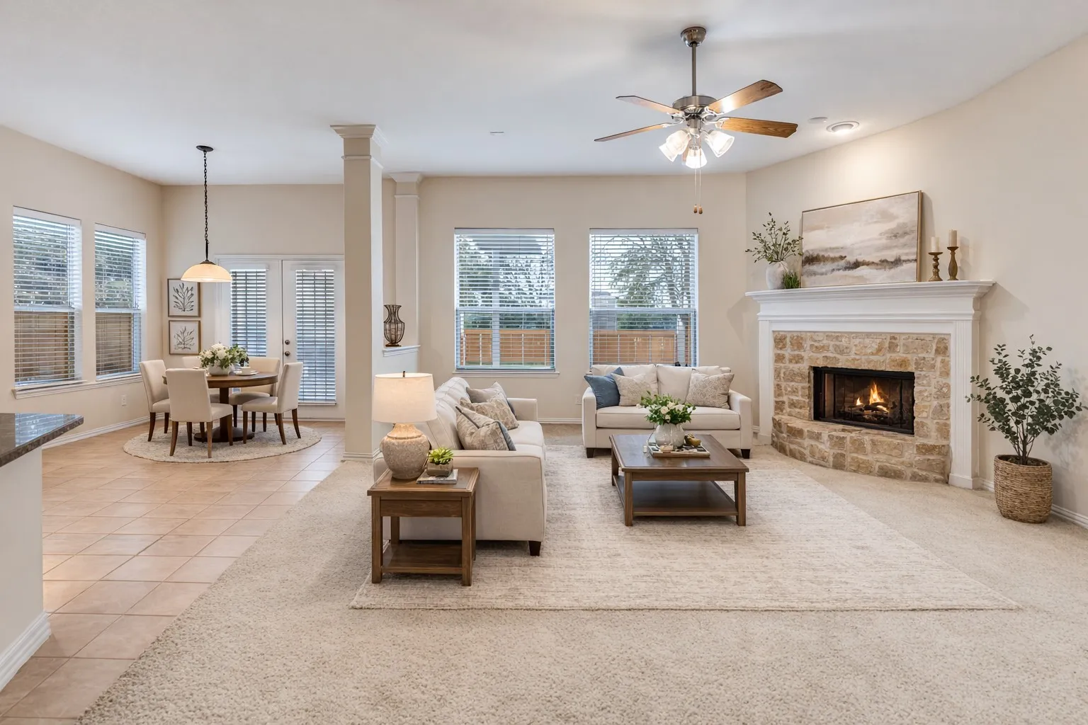 VIRTUALLY STAGED - Living and casual dining with plenty of space for entertaining. Gather around the stone fireplace for cozy evenings. Neutral colors mean you can put your own personality into the space.