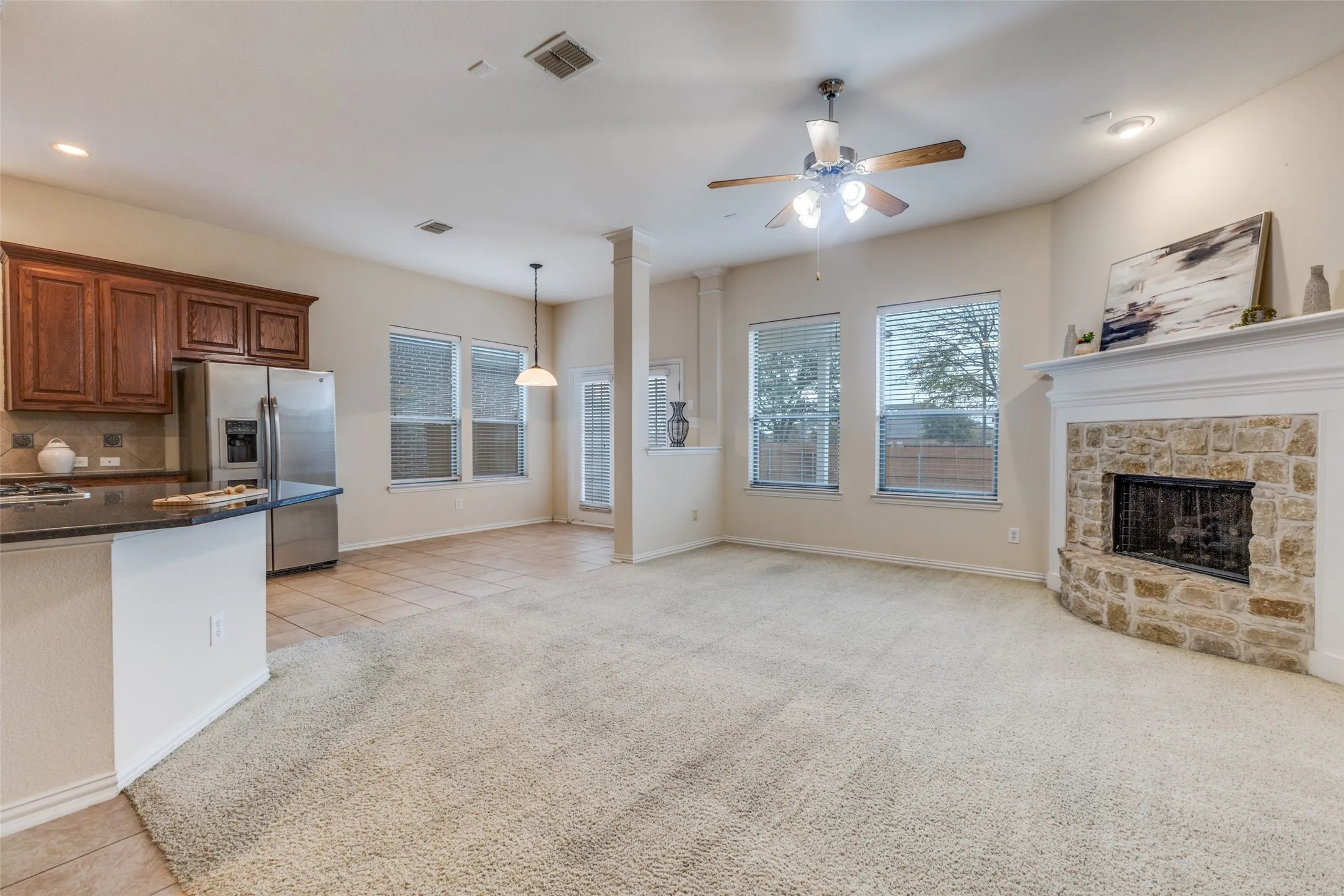 The family room is spacious and features a stone fireplace for cozy evenings!