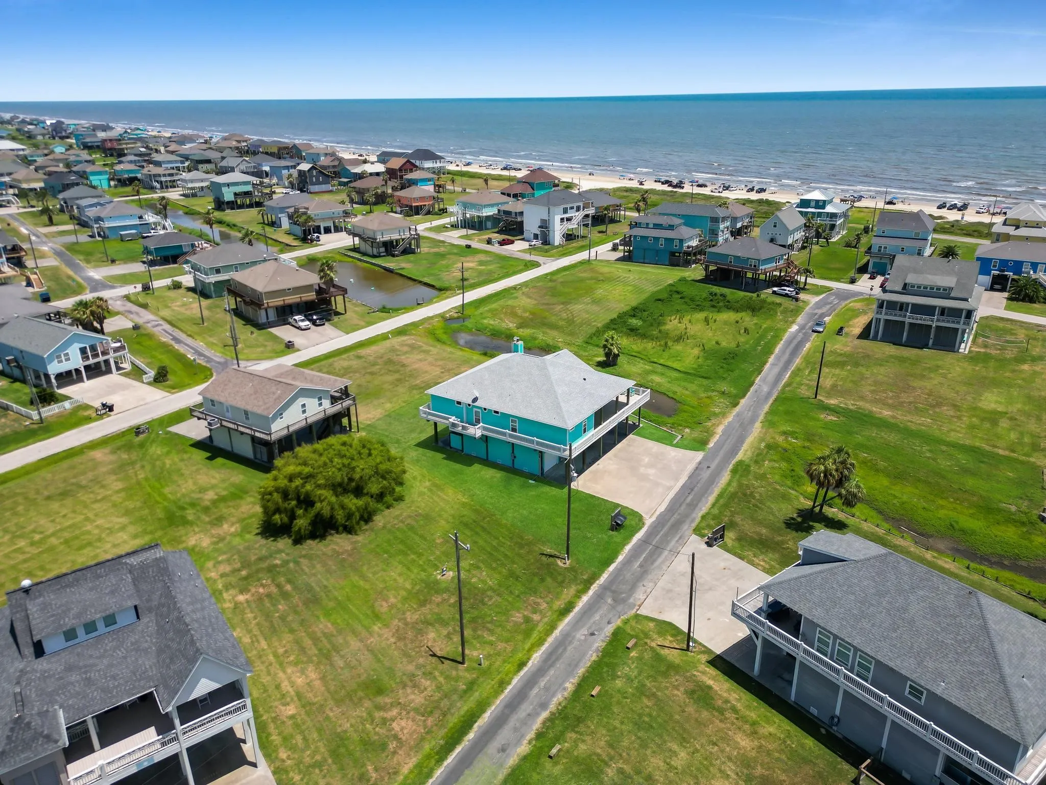 Expansive beachfront community featuring generous manicured lawns, mature landscaping, and direct coastal access