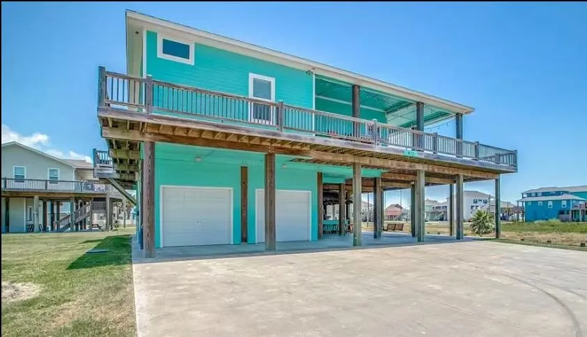 Rear view of house with a garage and driveway
