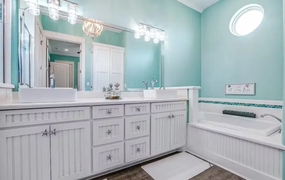 Full bathroom featuring double vanity, dark wood-style floors, and a bath