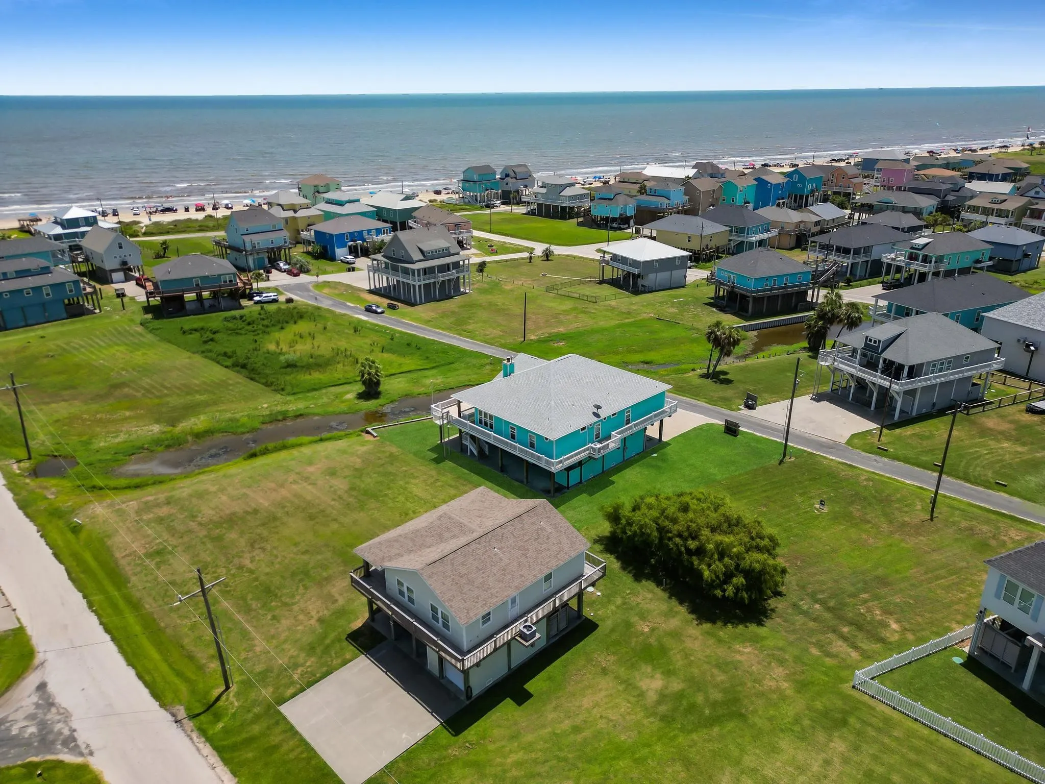 Coastal community with elevated homes and an expansive shoreline