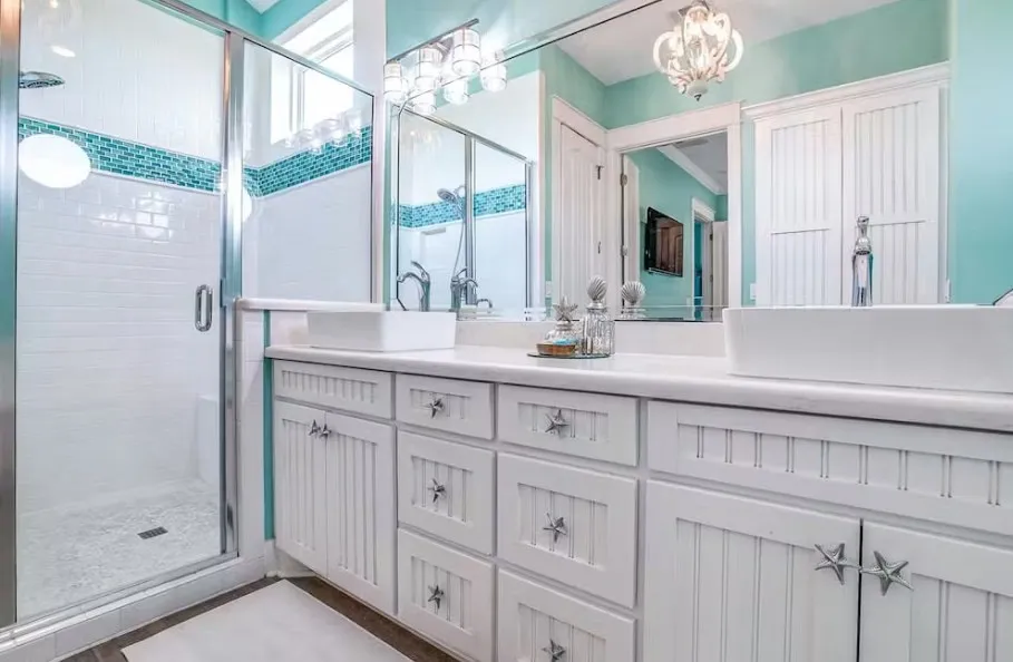 Full bathroom featuring a shower stall, vanity, and a chandelier