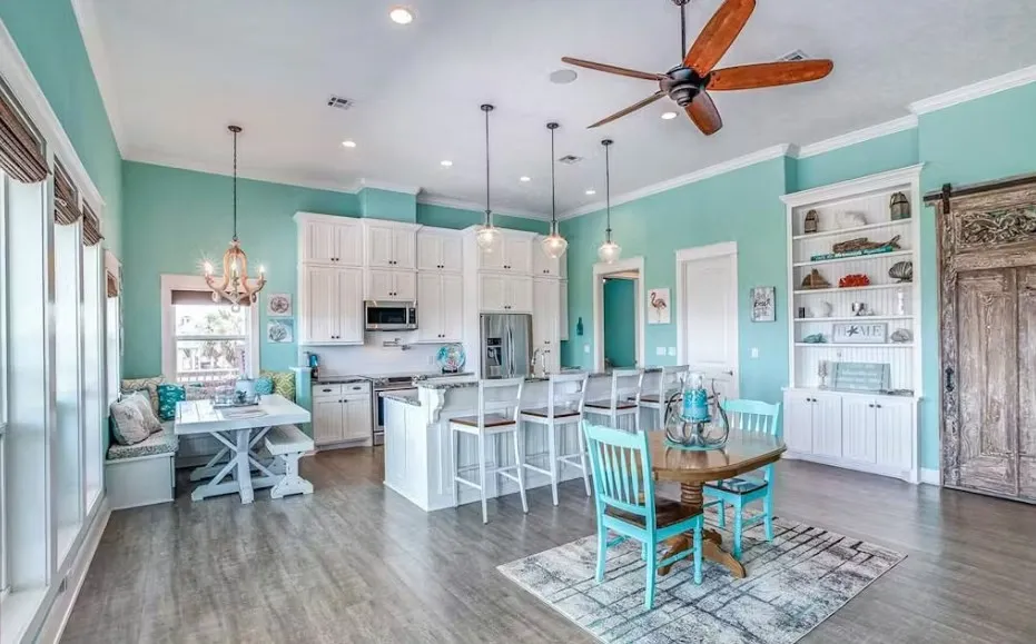 Dining space featuring ornamental molding, a chandelier, a barn door, light wood-style floors, and recessed lighting