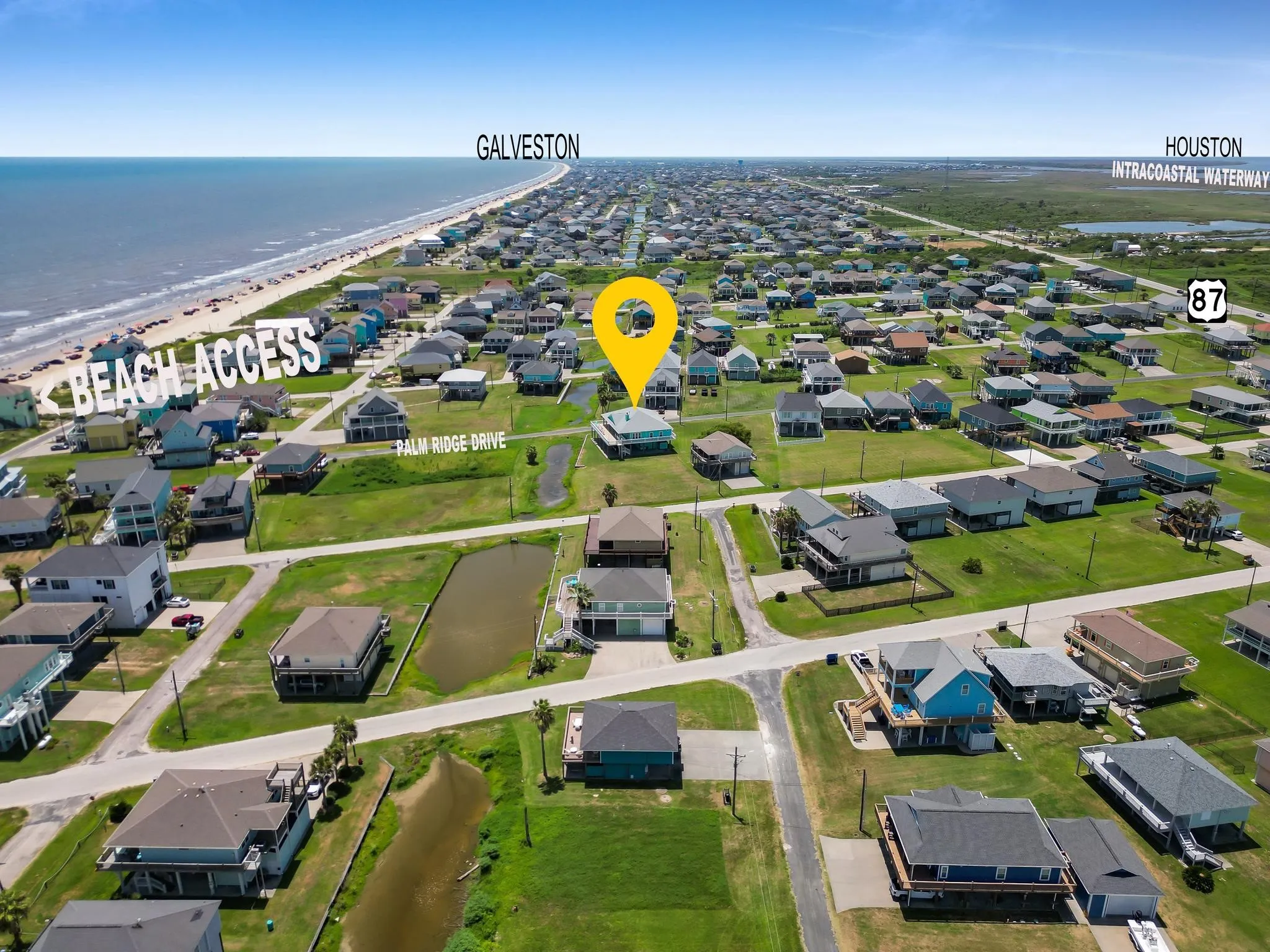 Aerial view of this residential lot in an established coastal community near Galveston, featuring manicured landscaping, paved driveway access, and proximity to beach amenities