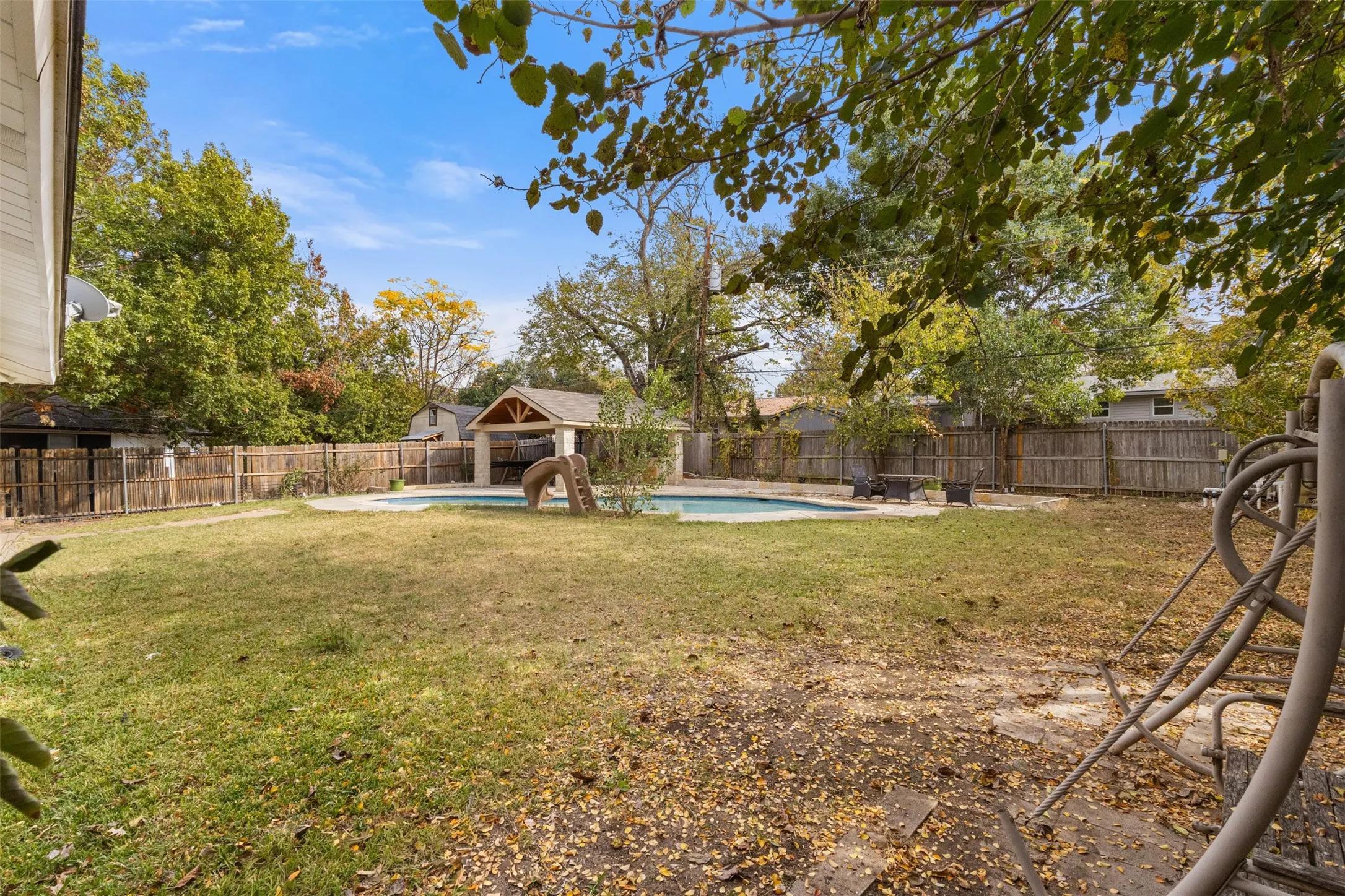 Fenced backyard with a patio