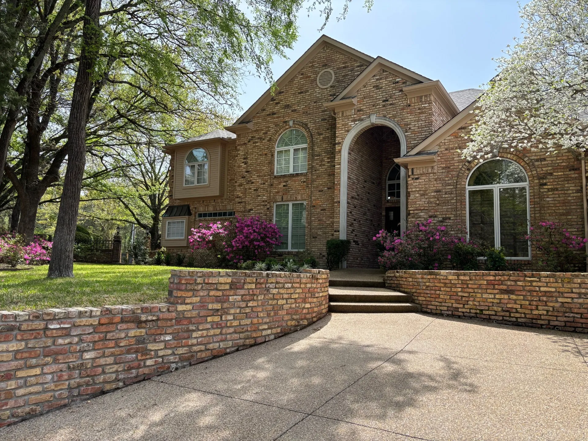 View of front of property featuring brick siding and a front lawn