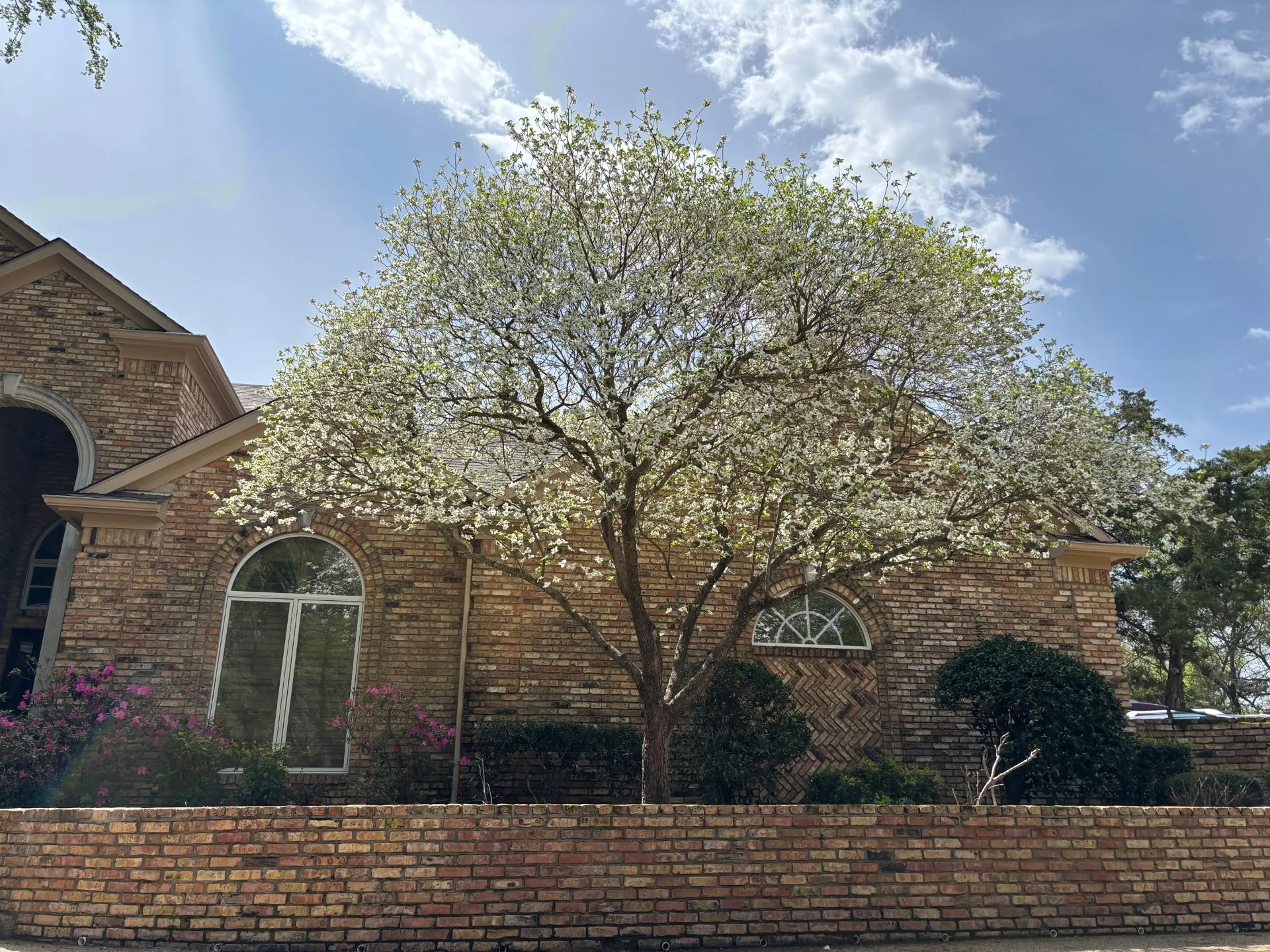 View of property exterior featuring brick siding