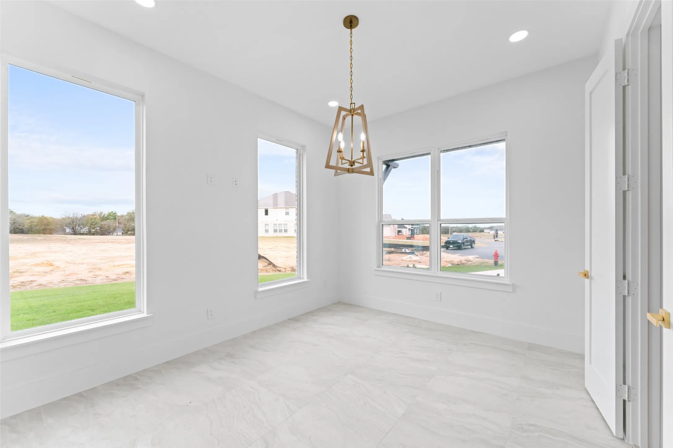 Unfurnished dining area featuring a chandelier and recessed lighting