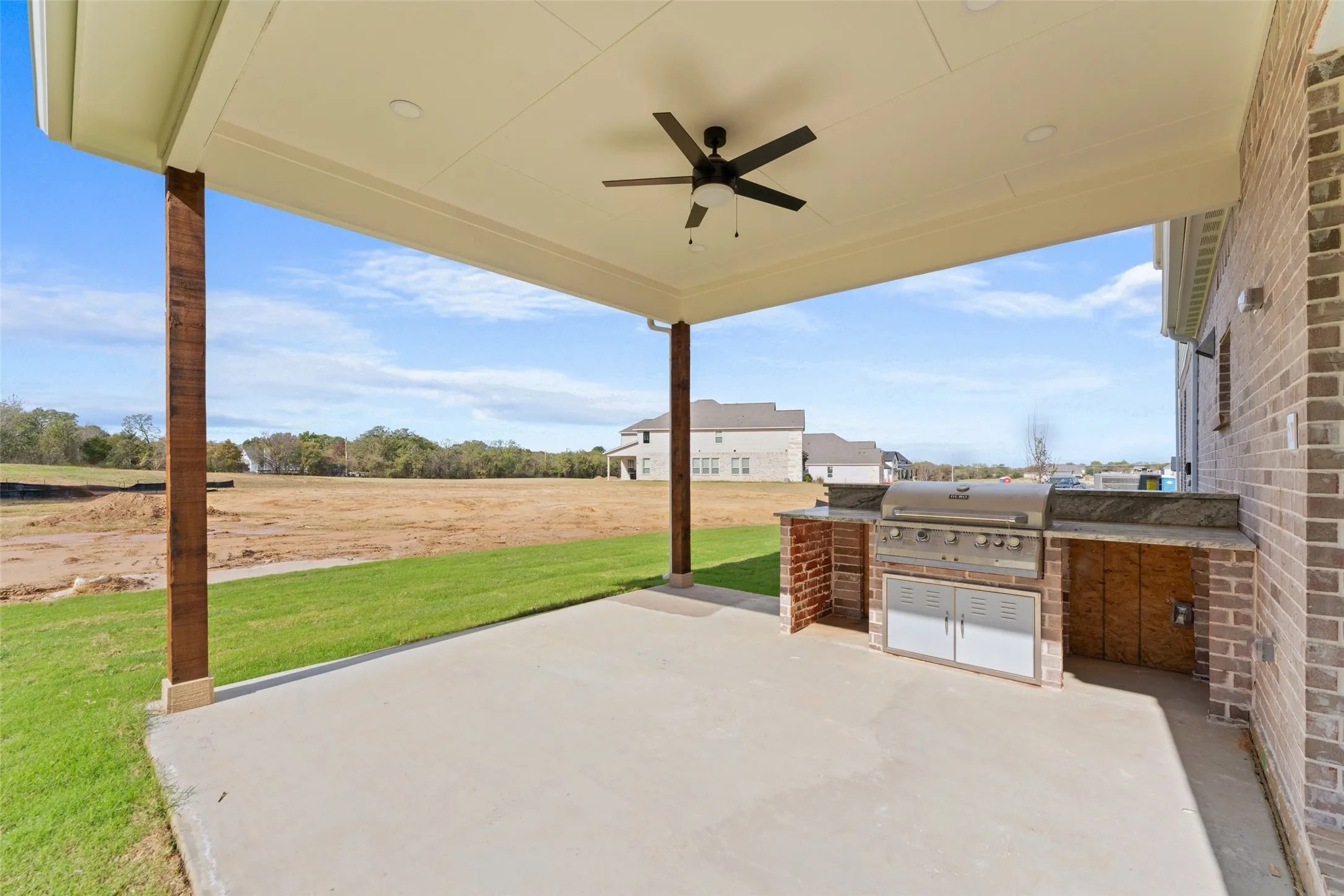 View of patio featuring an outdoor kitchen and ceiling fan