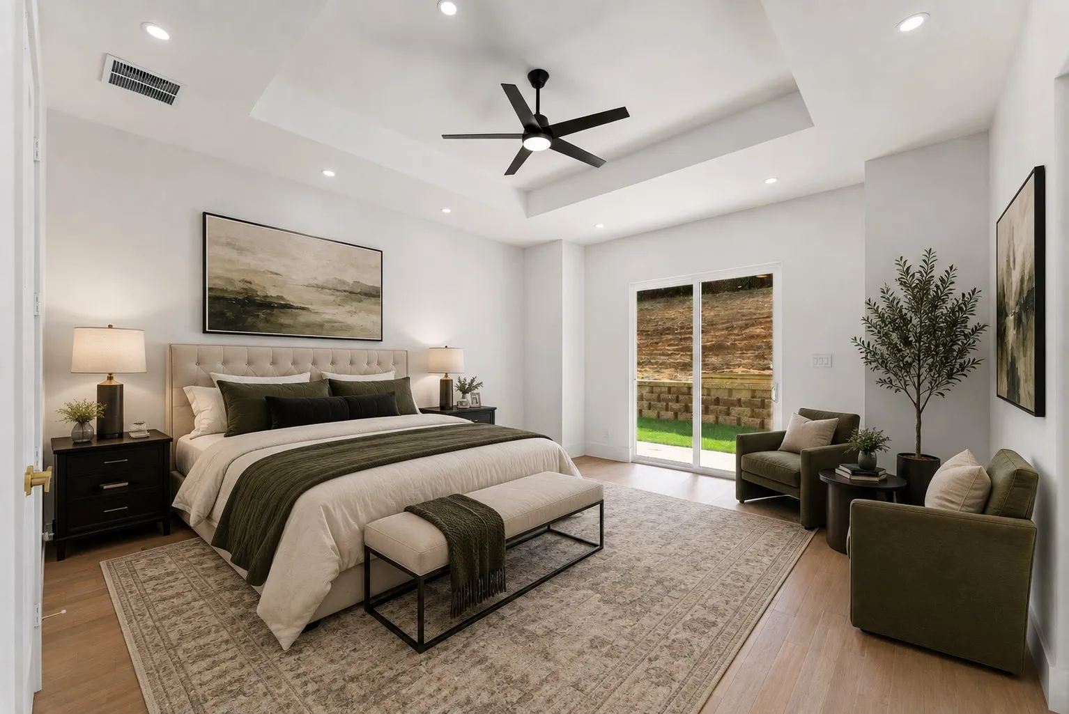 Spacious bedroom featuring light wood-finish flooring, a recessed ceiling with a black ceiling fan, and recessed lighting