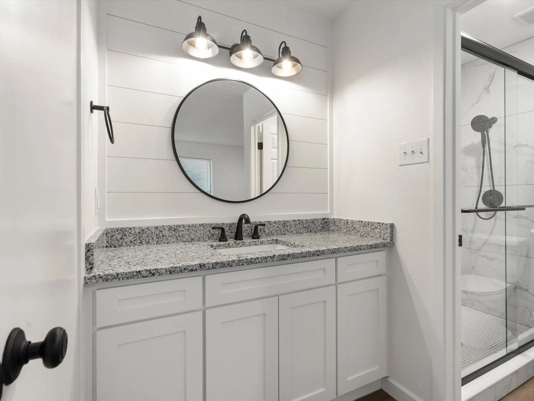 Full bathroom featuring vanity and a marble finish shower