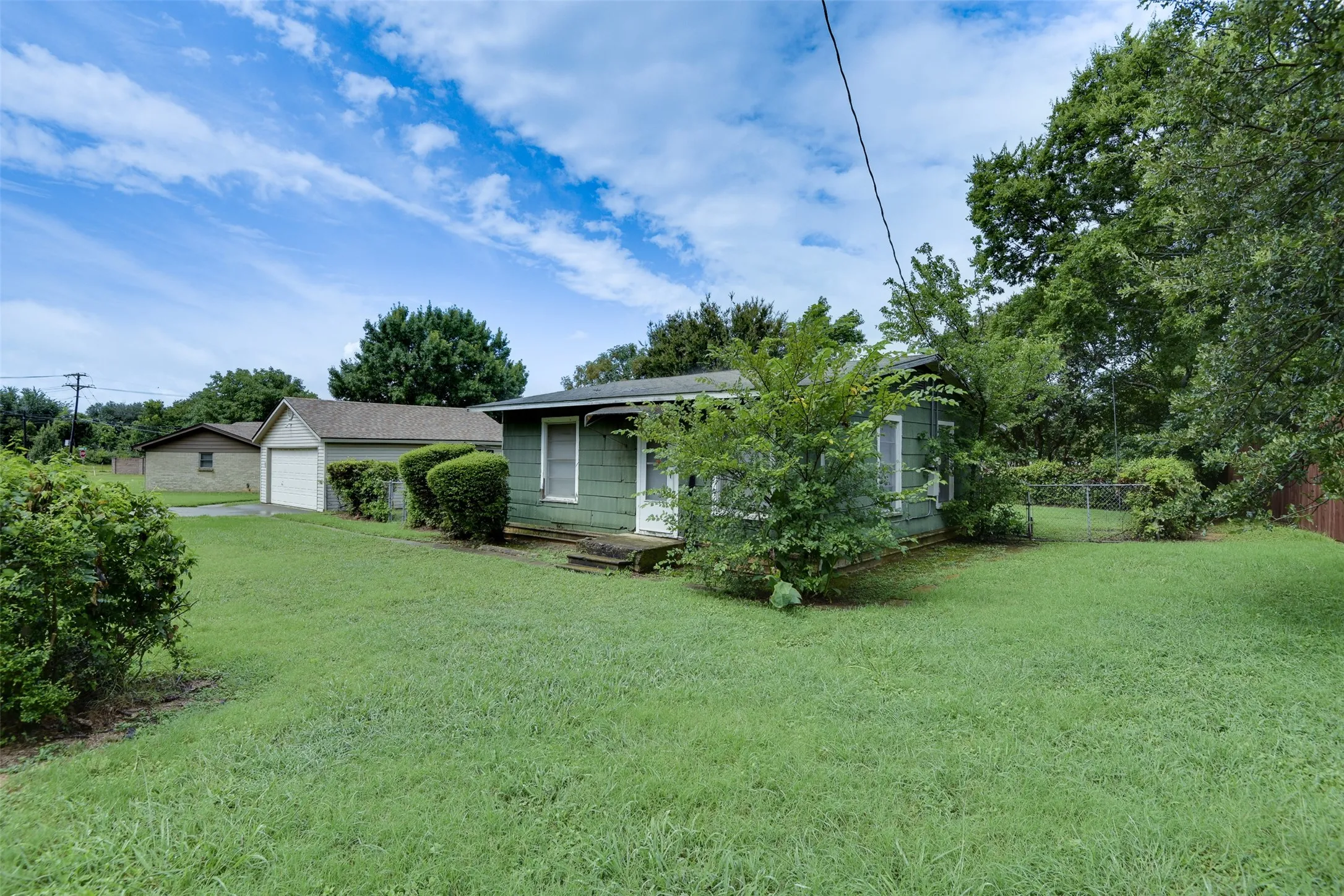 Back of property with a garage