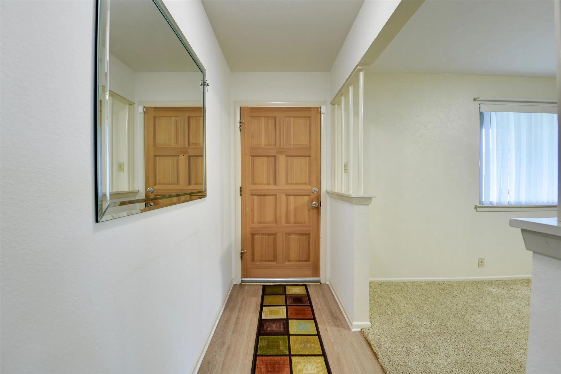 Entryway featuring baseboards and wood finished floors