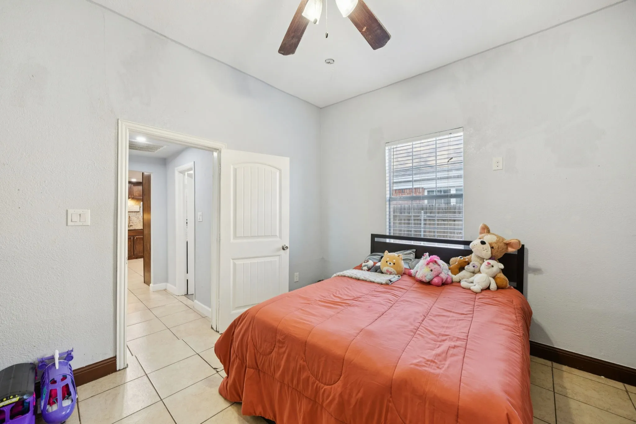 Bedroom featuring light tile patterned flooring and ceiling fan