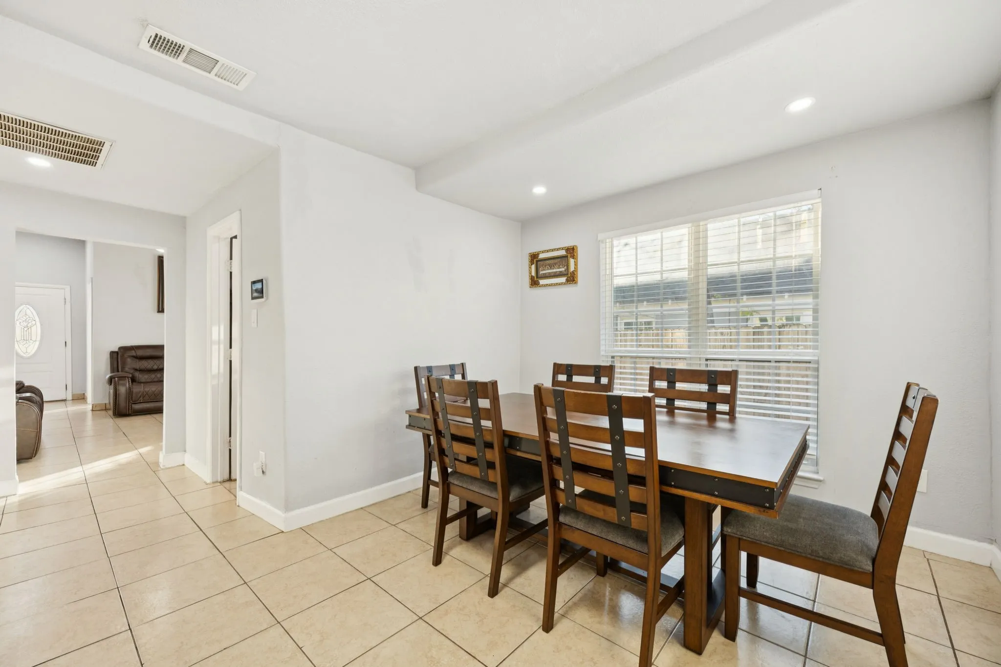 Dining room featuring light tile patterned floors and recessed lighting