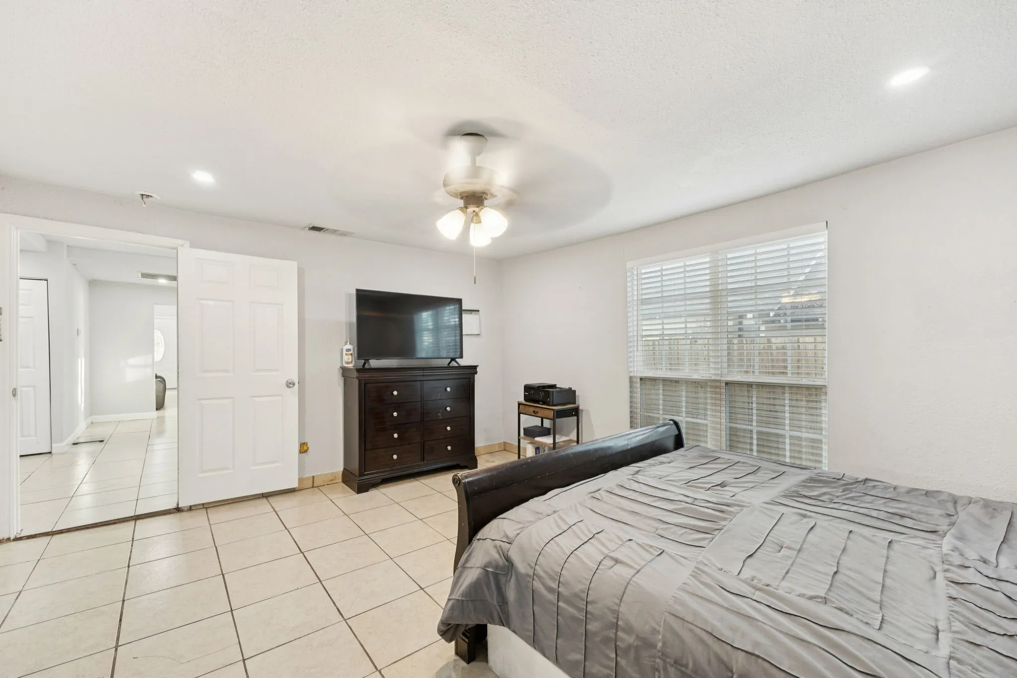 Bedroom featuring recessed lighting, light tile patterned floors, and a ceiling fan