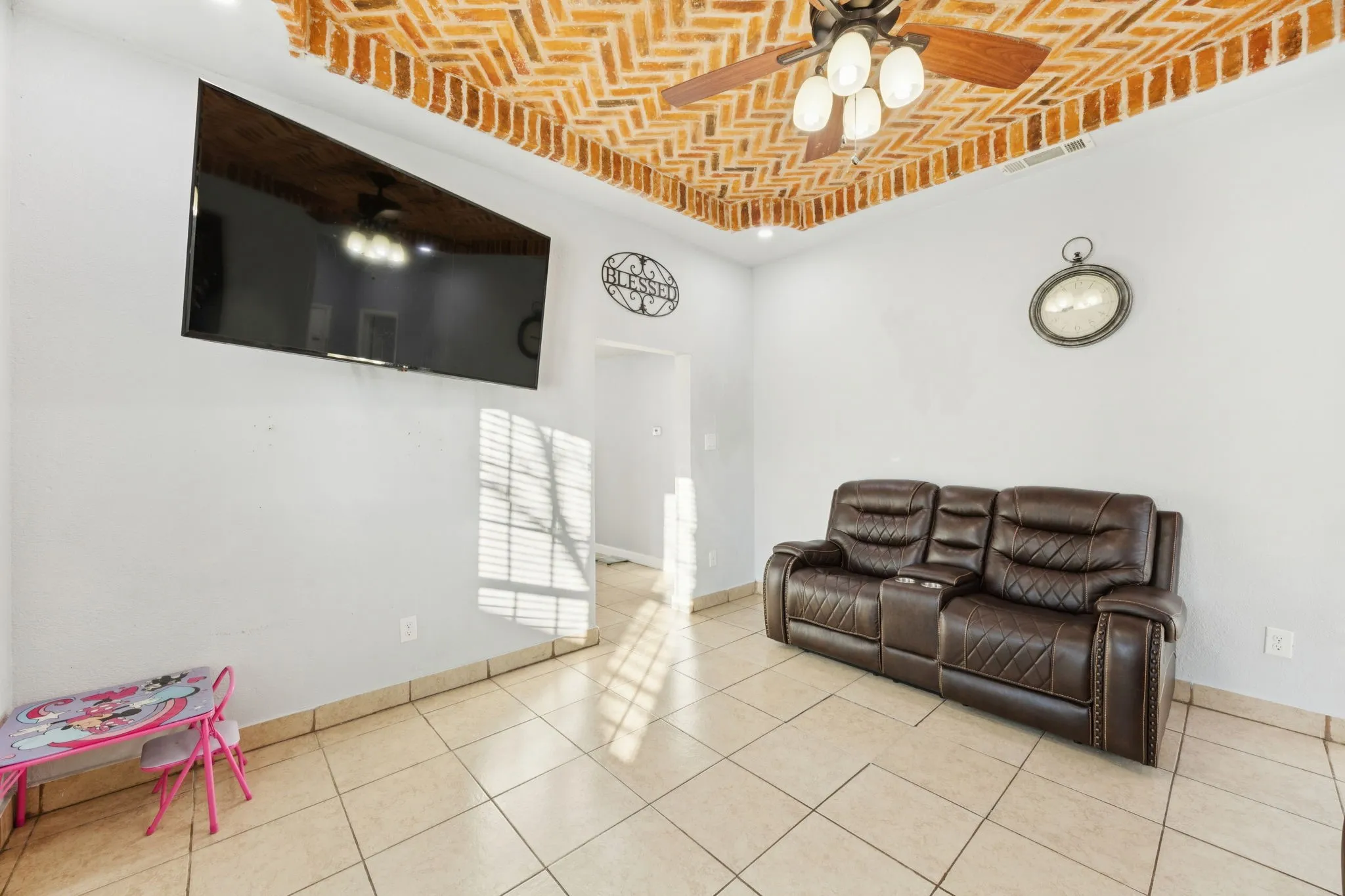 Living area featuring brick ceiling, ceiling fan, tile patterned flooring, and recessed lighting