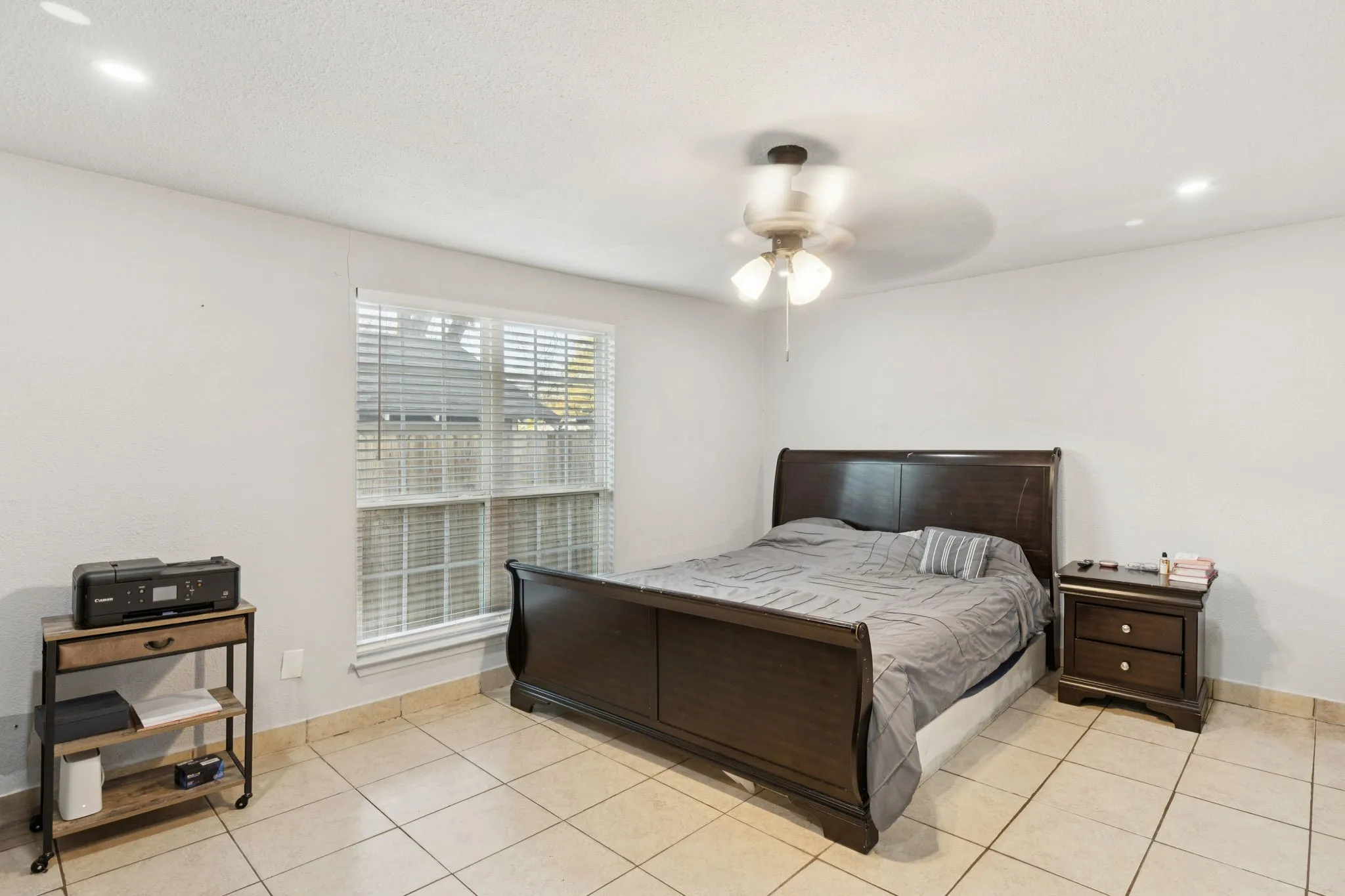 Bedroom featuring recessed lighting, ceiling fan, and light tile patterned flooring