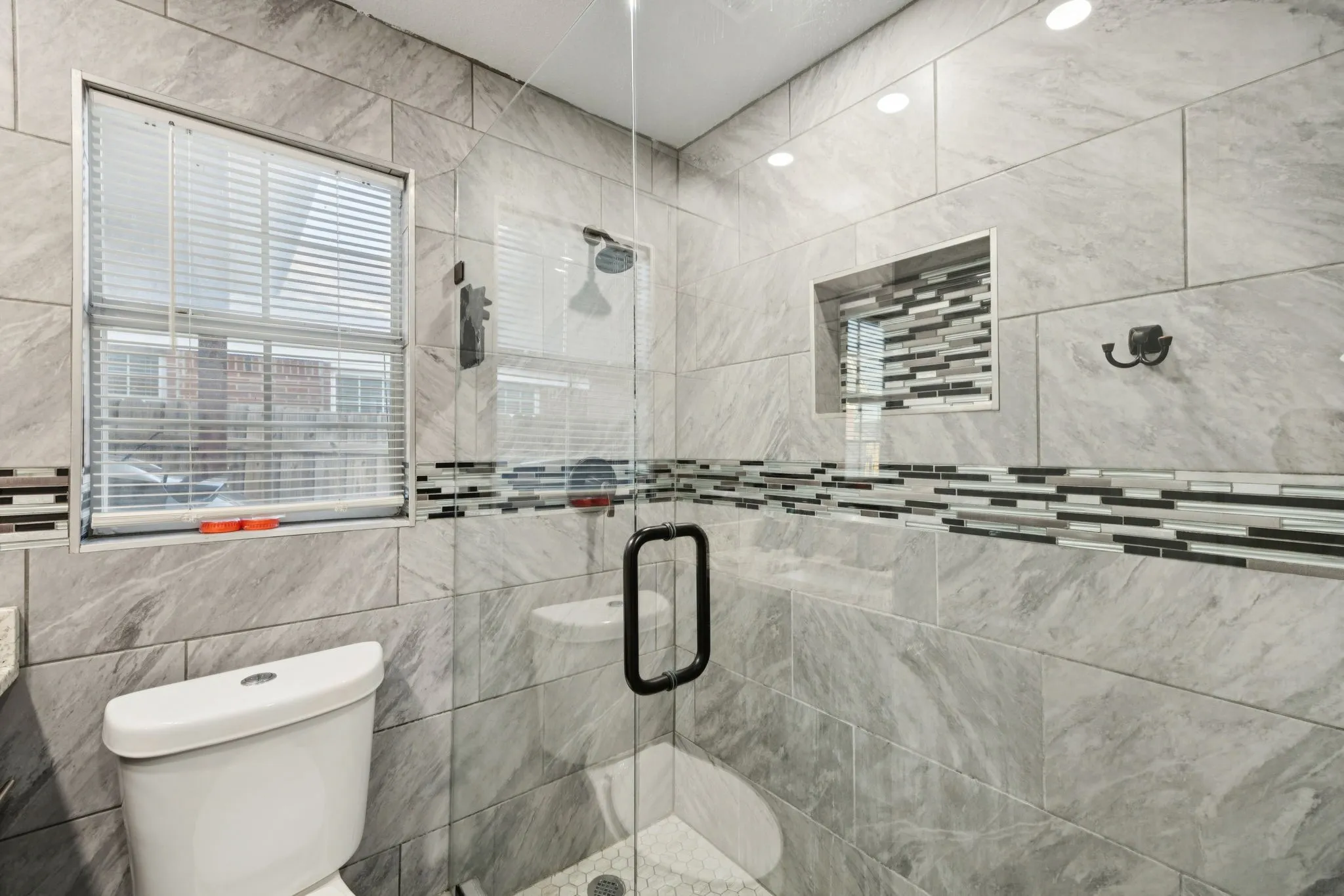 Full bathroom with a shower stall and healthy amount of natural light