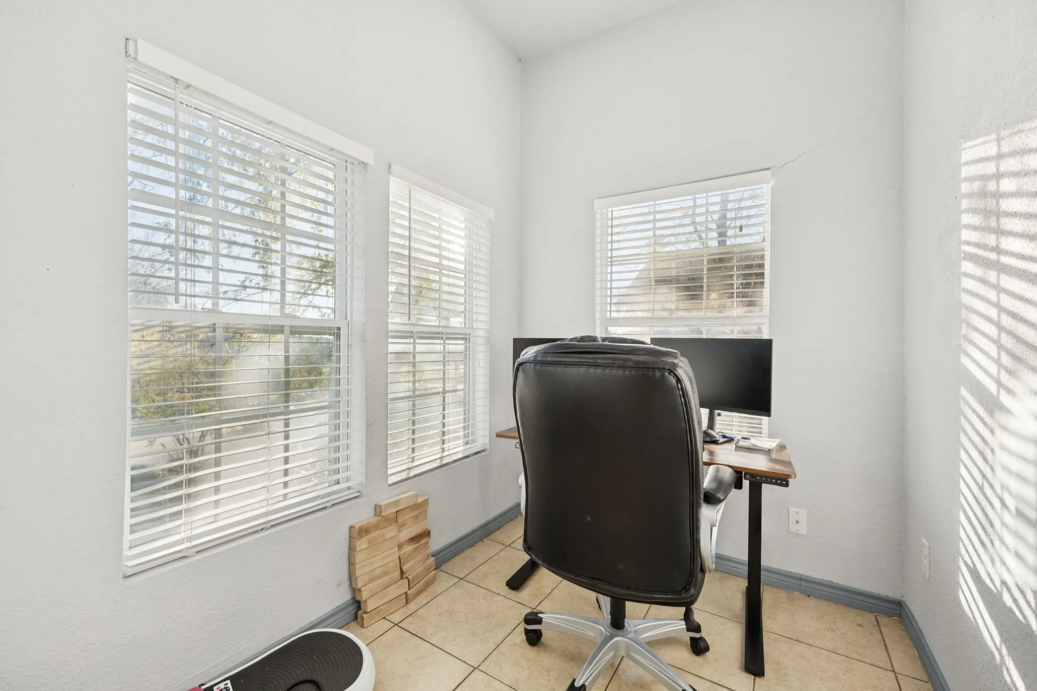 Office space with light tile patterned floors and baseboards