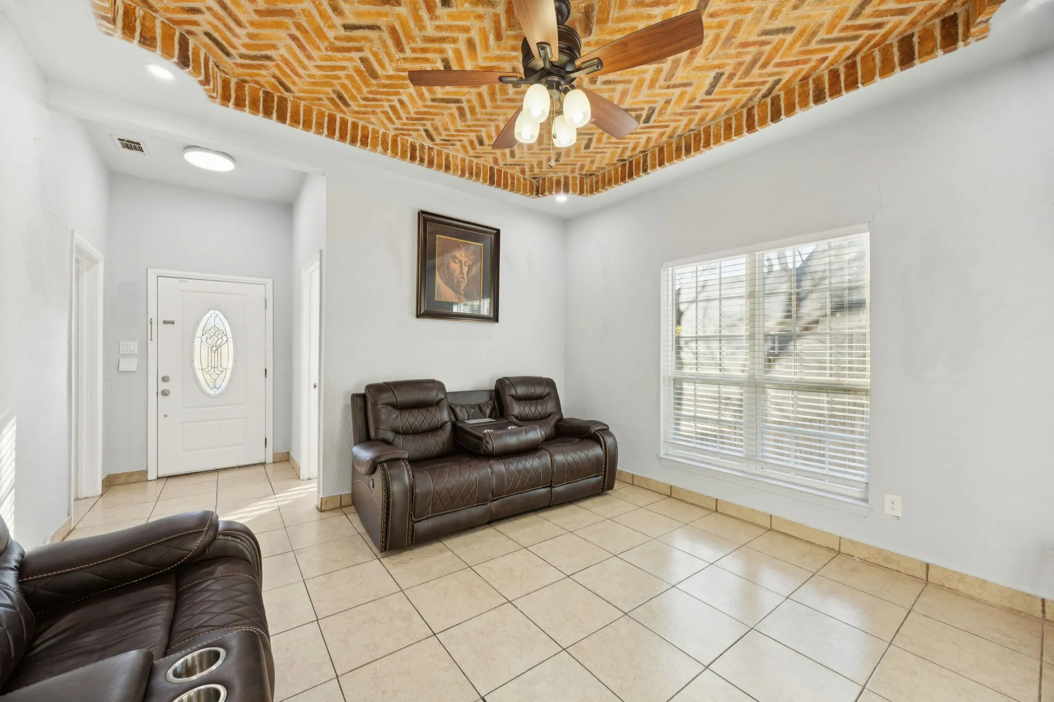 Living room with brick ceiling, a ceiling fan, light tile patterned flooring, and recessed lighting