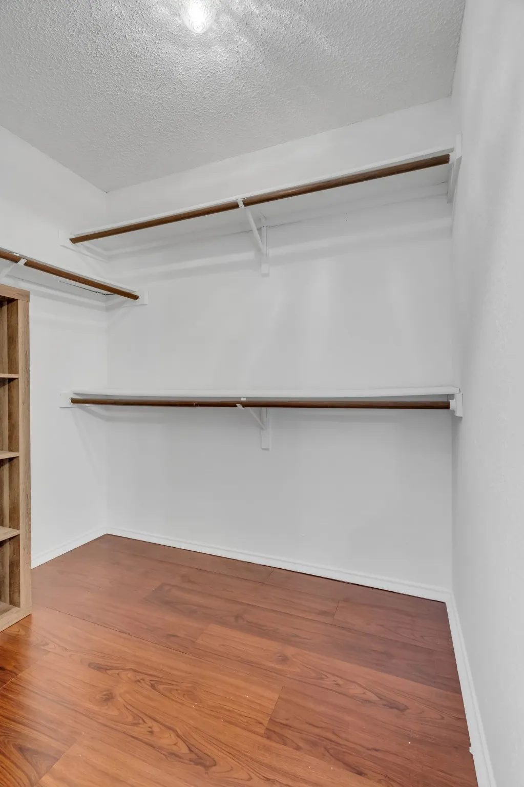 Spacious closet with wood finished floors