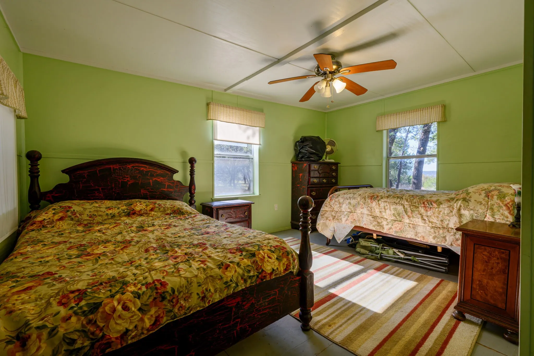Bedroom featuring multiple windows, a ceiling fan, and crown molding