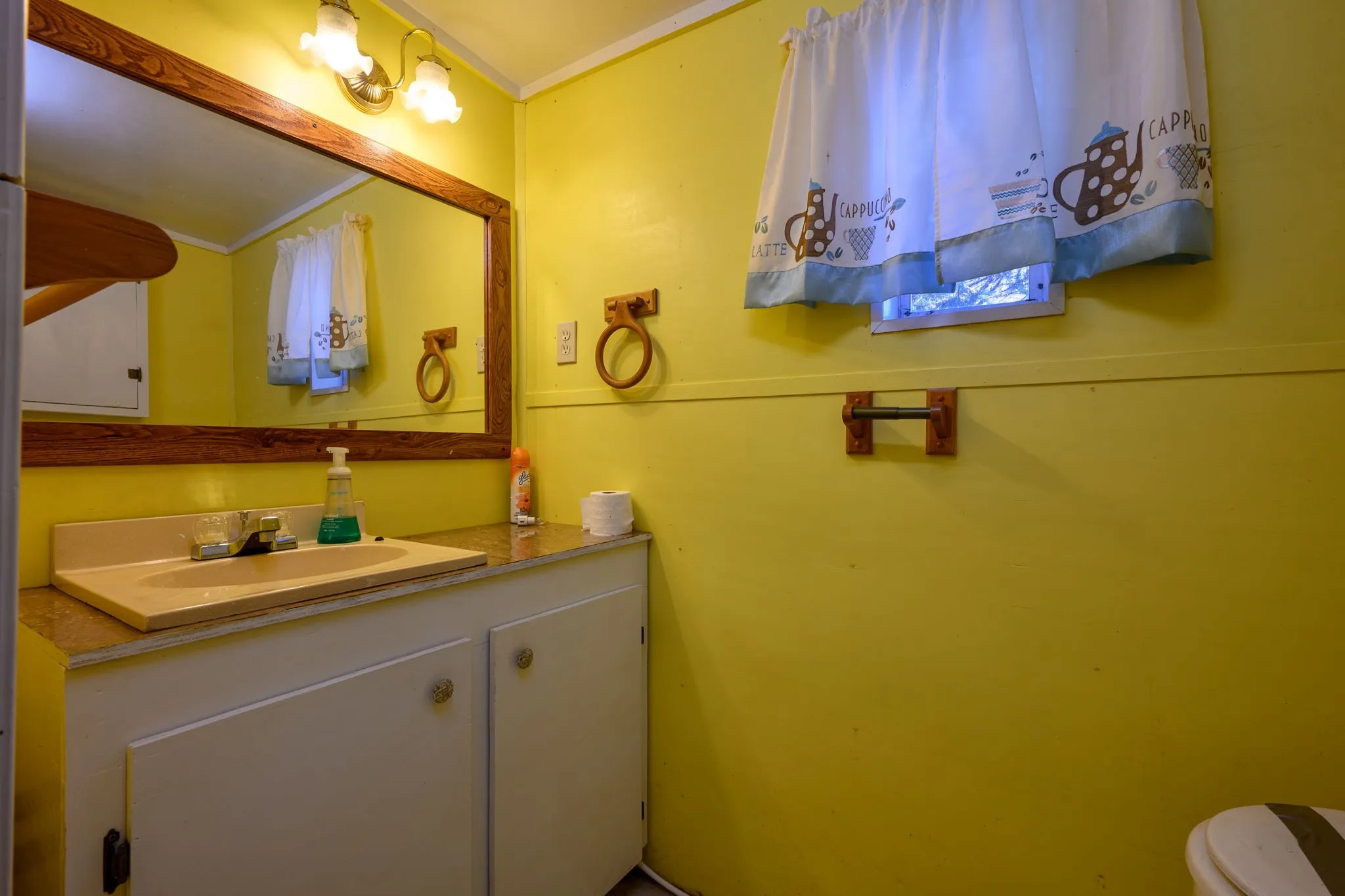 Half bath with ornamental molding and vanity