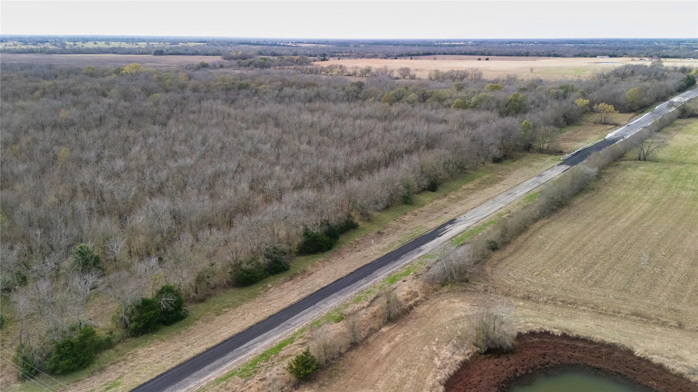 Overview of rural landscape featuring large plots for crops