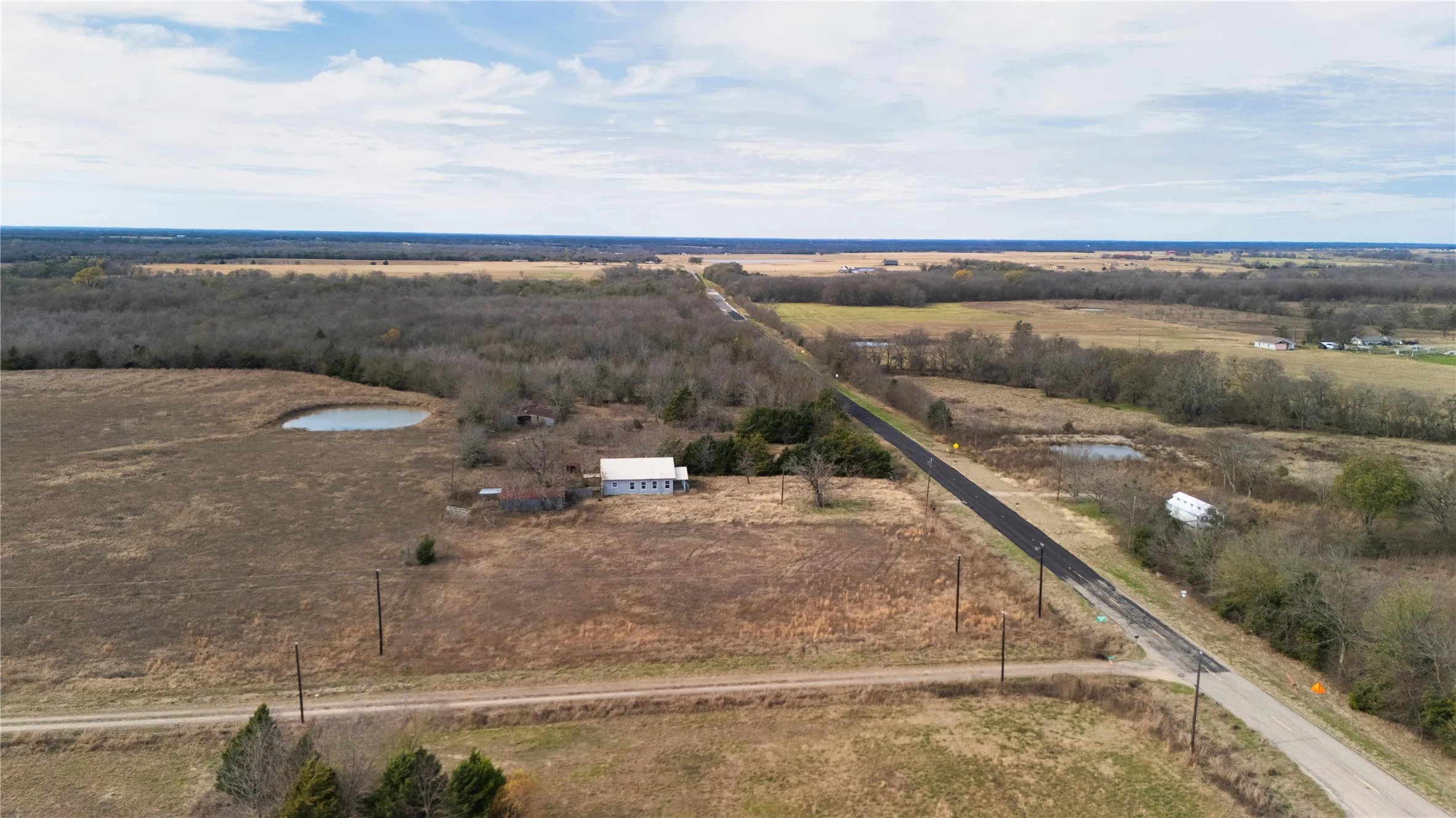 Aerial view of property and surrounding area with rural landscape