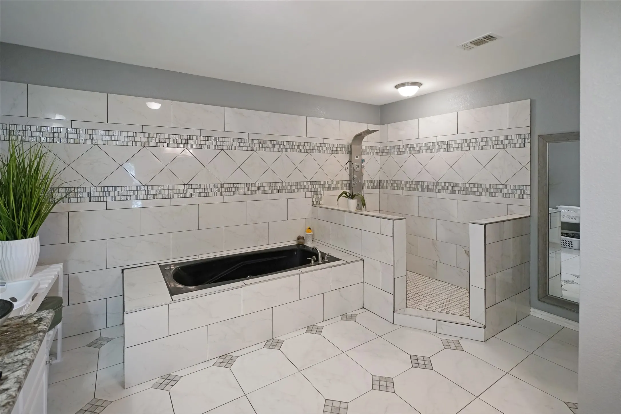 Full bath with a garden tub, tile patterned floors, and a walk in shower