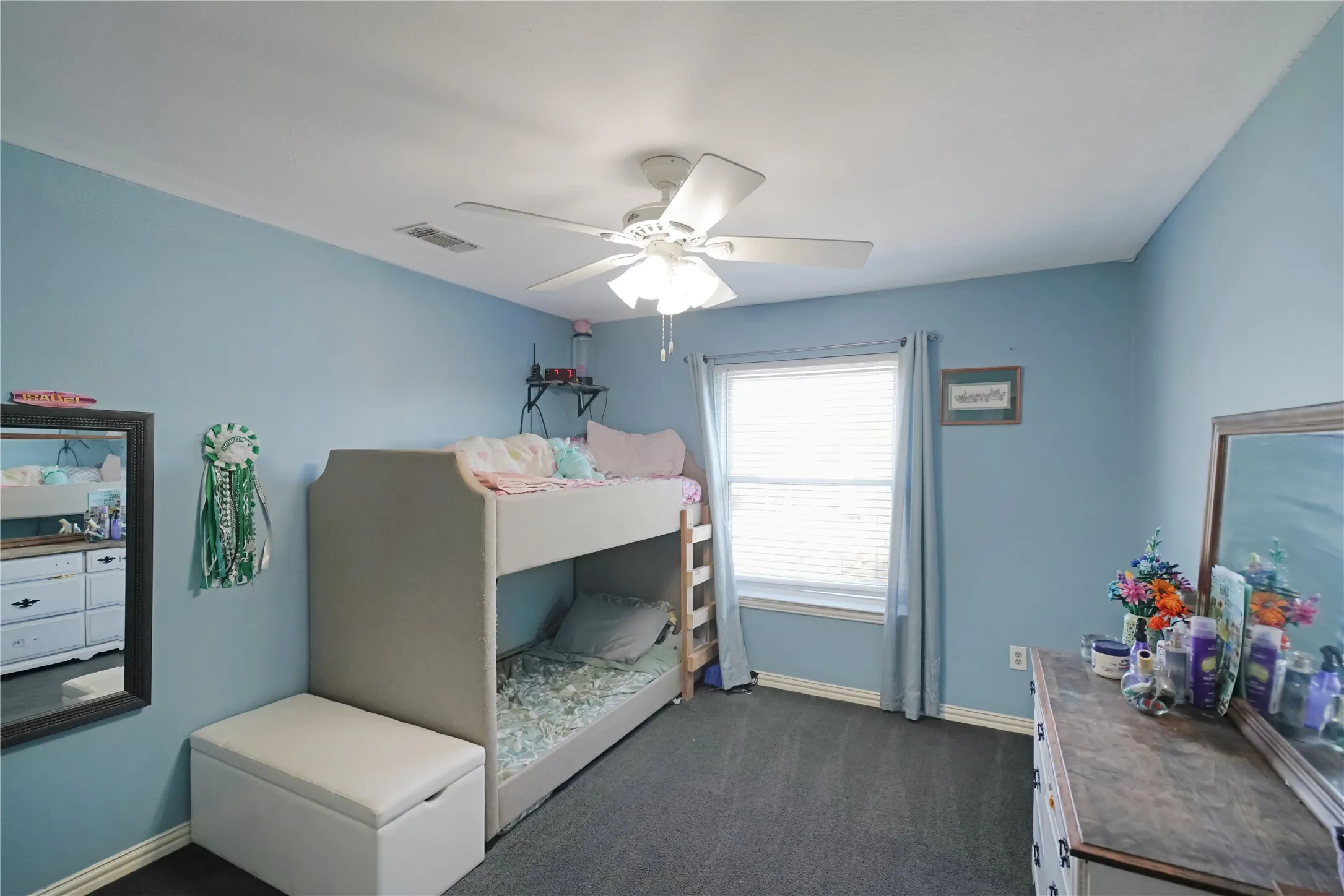Bedroom with dark colored carpet and ceiling fan