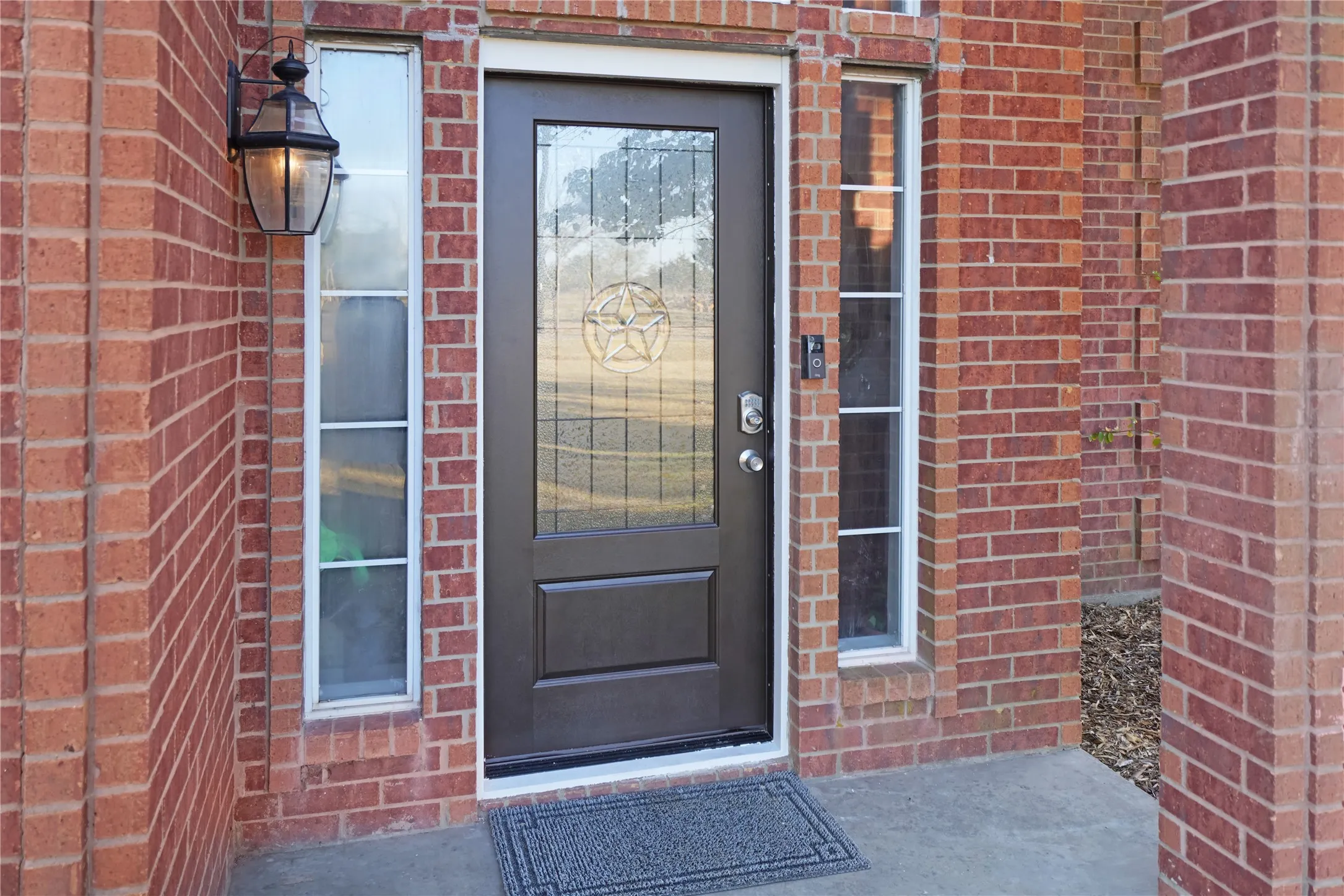 View of exterior entry featuring brick siding